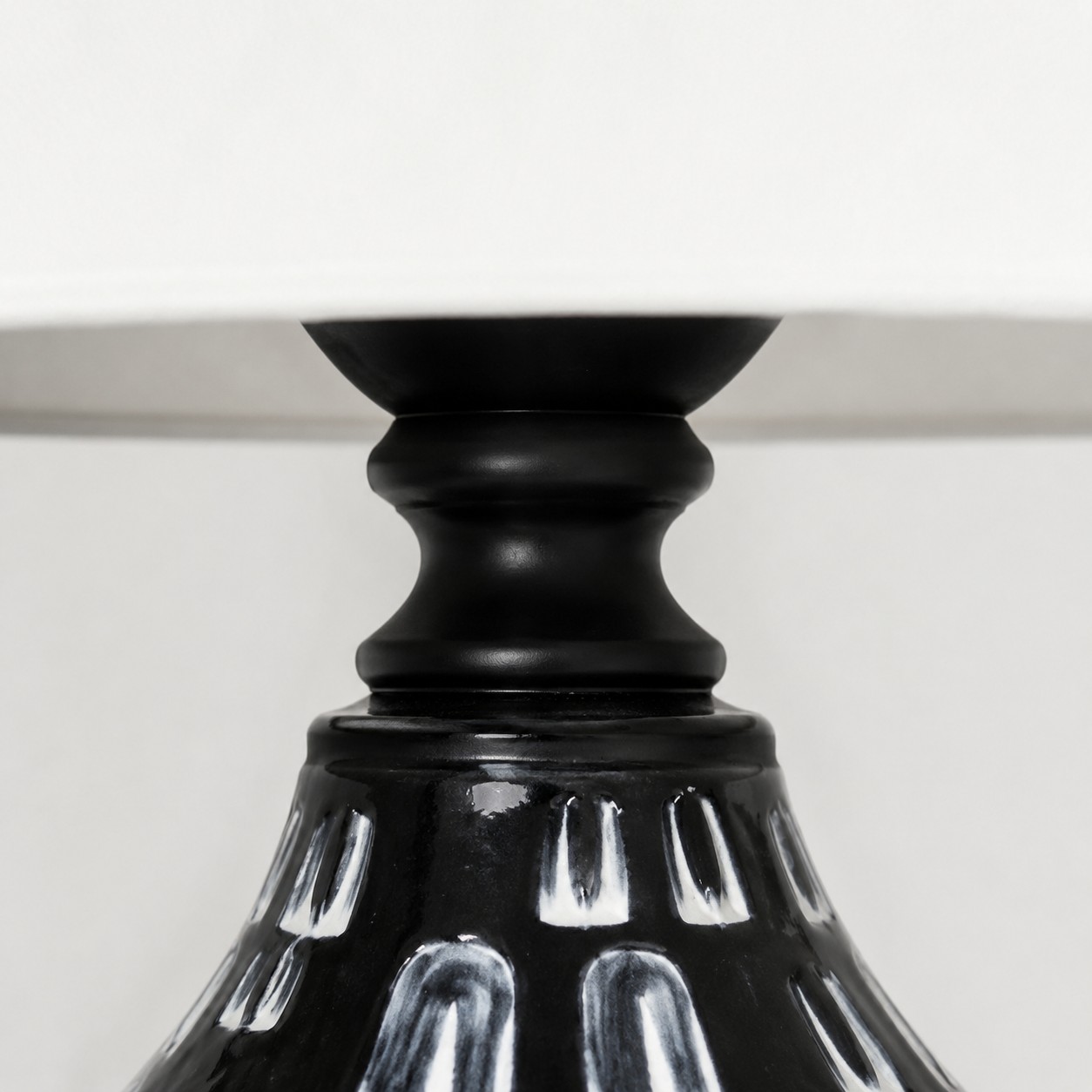 Glossy black ceramic neck detail on table lamp